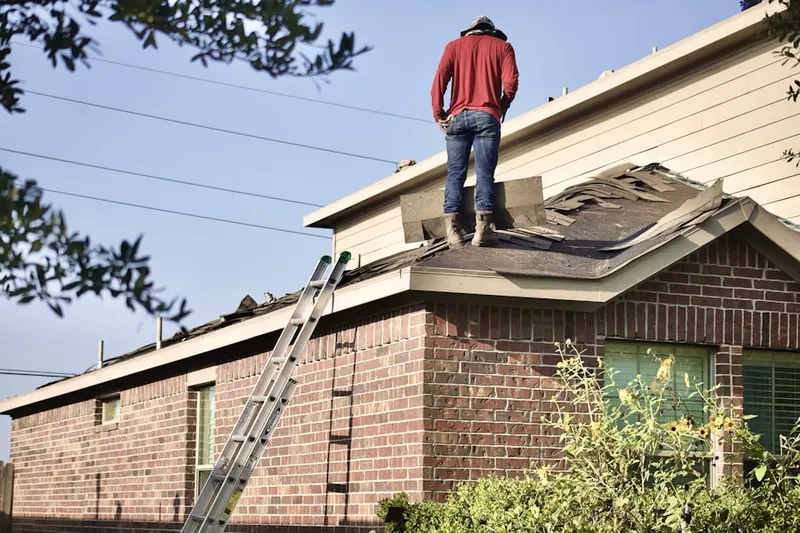 Professional roofer working on a residential roof in Riviera